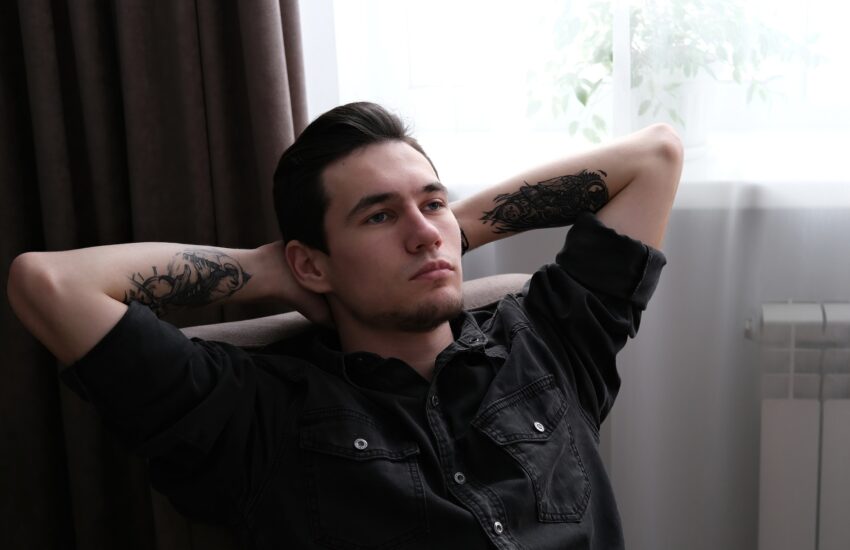 Serious sad young man thinking about problem. Depression and anxiety disorder concept.