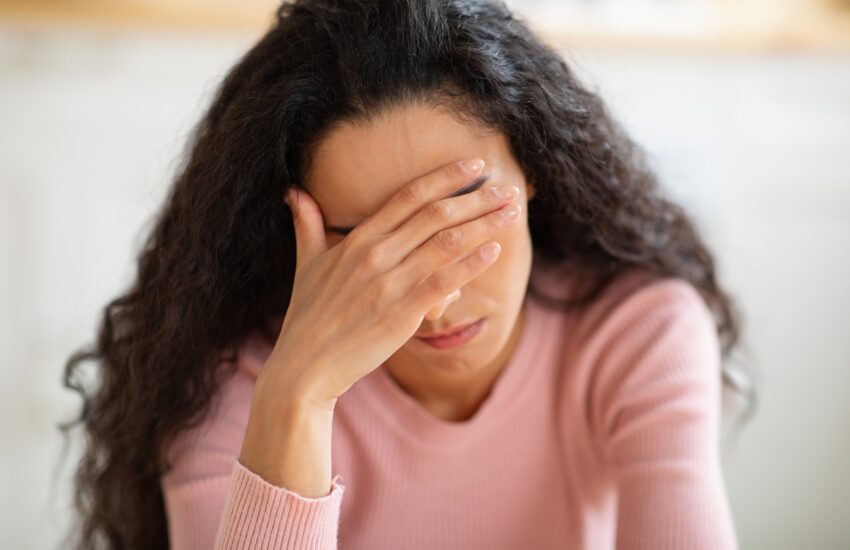 Depression Concept. Closeup portrait of stressed young woman touching head in despair